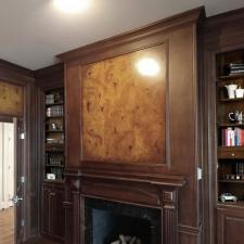 Faux burl and wood grained panels and mahogany wood grained walls fireplace